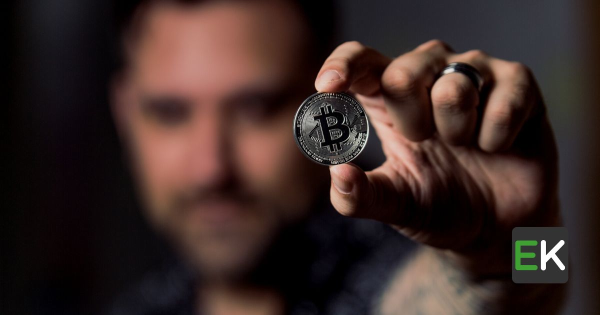 Person holding bitcoin made out of silver